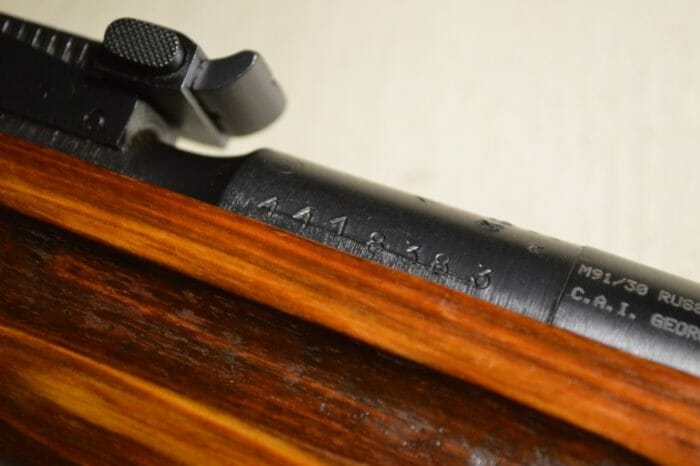 Notice the deep-cut finger grooves in the stock. Also, take note of the lined out serial number on the barrel. That was the serial number for the scope that used to adorn the rifle. The pair would have been matched prior to issue.