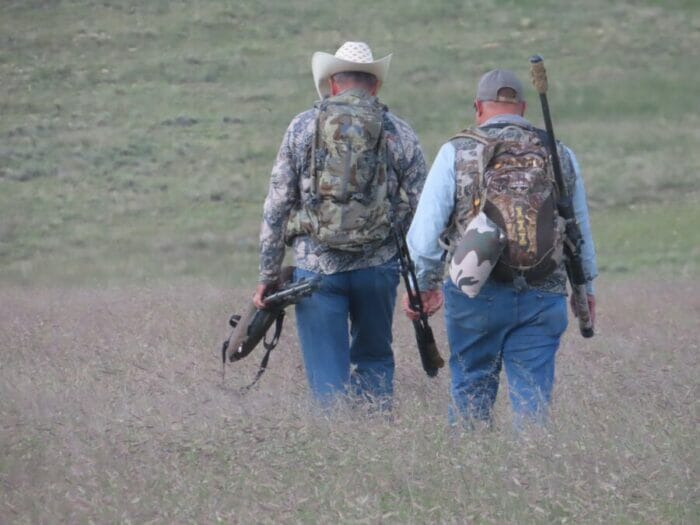 Outfitter Randy Lewis (RLE Outfitters) and hunter Andy Iverson head toward a distant pronghorn