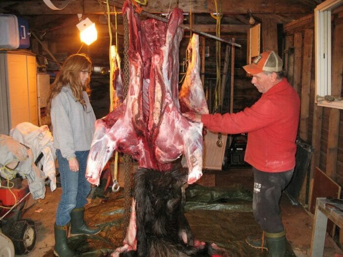 Standing with Dad talking about the moose hunt and helping process for butchering.