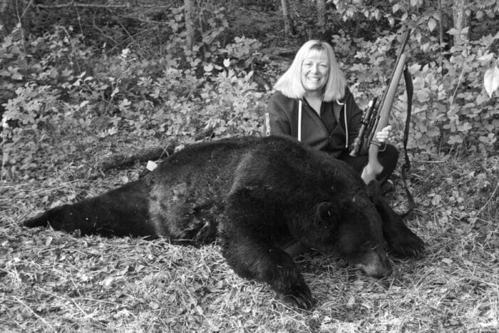 Mossberg's Linda Powell with her huge bodied Alberta, Canada black bear taken with a .450 Bushmaster Hornady bullet.