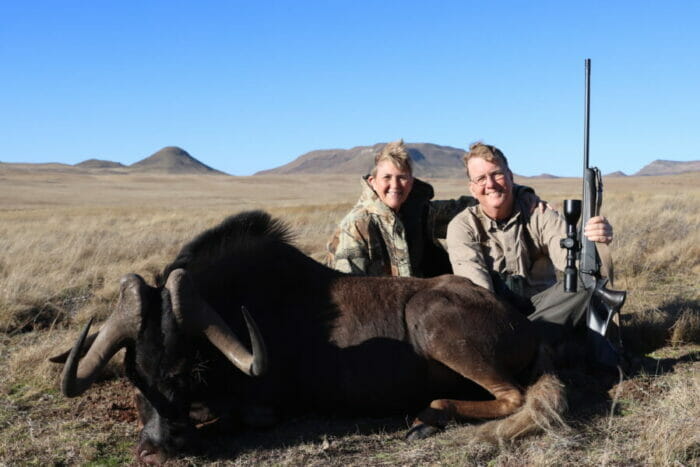 Wife, Frances, and author pose with the Black Wildebeest bull