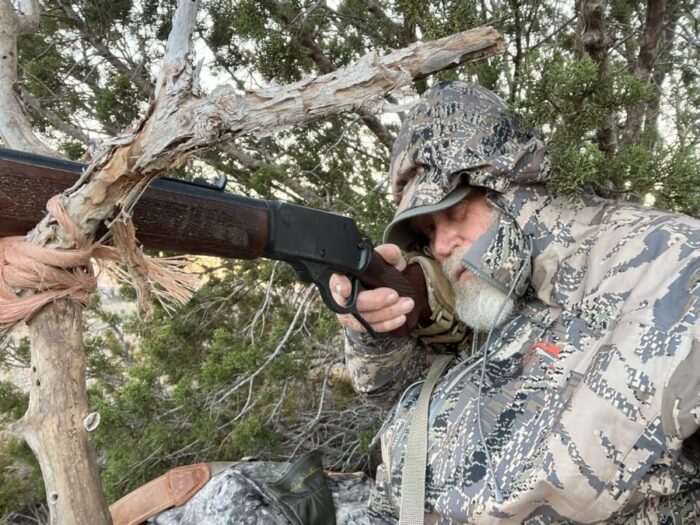 Larry takes aim with his Rossi R95, .30-30 Win at a doe, using makeshift shooting sticks, while shooting Hornady ammol