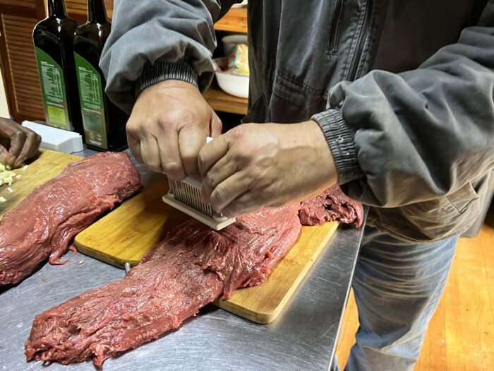 Using the meat tenderizing tool along the length of the Eland loins