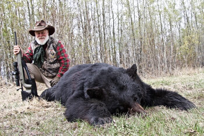 Larry with his Alberta black bear taken while hunting with GrandSlam Hunting Adventures.